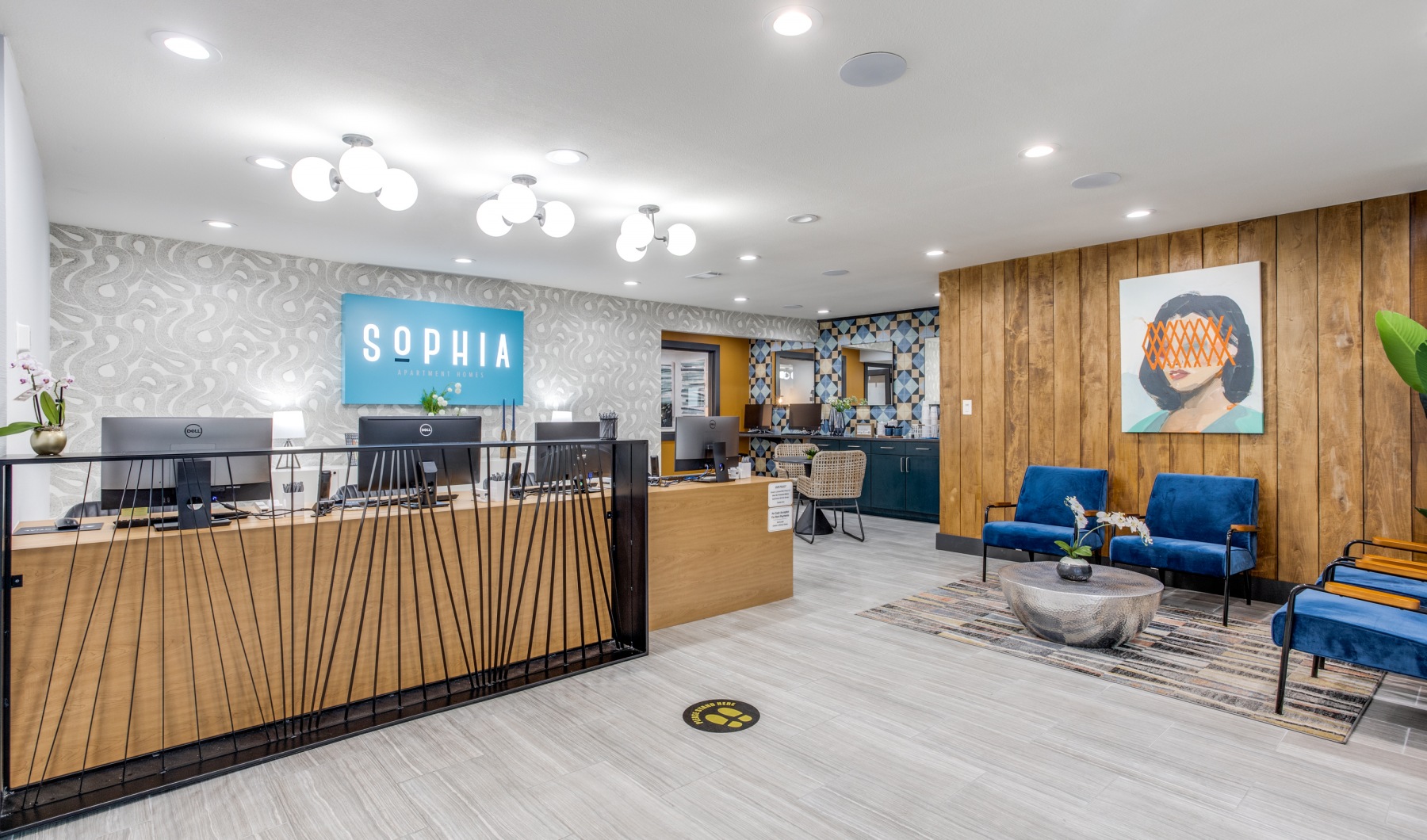 the lobby of a modern office building with a reception desk at The  Sophia